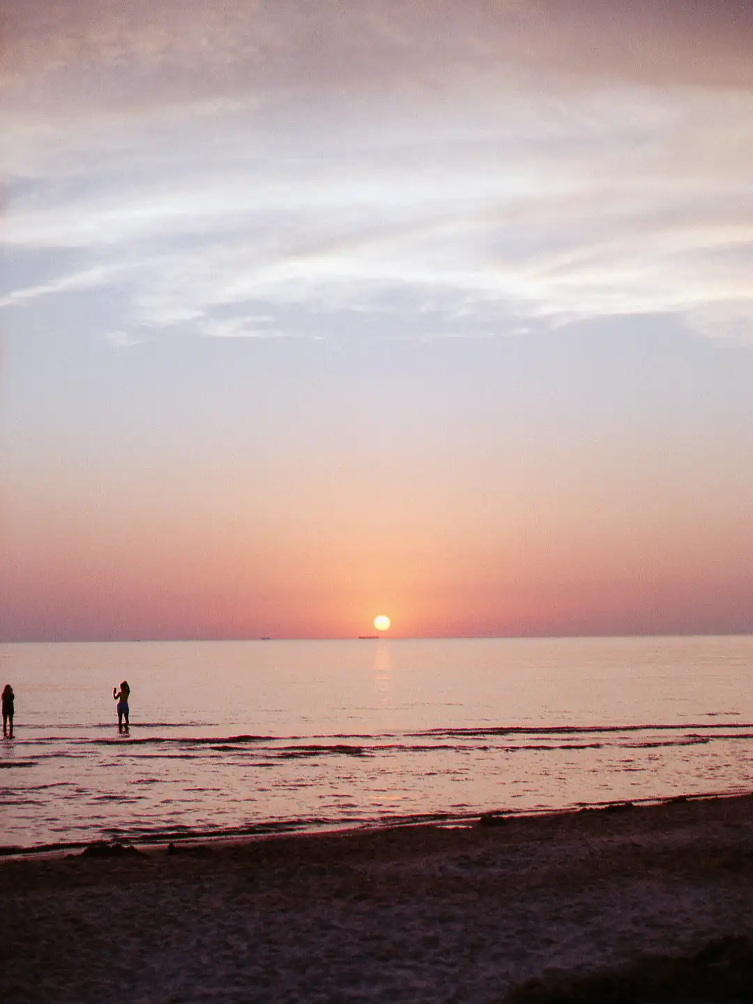 A beautiful sunset depicted above a calm sea. Created and photographed by Hiroku