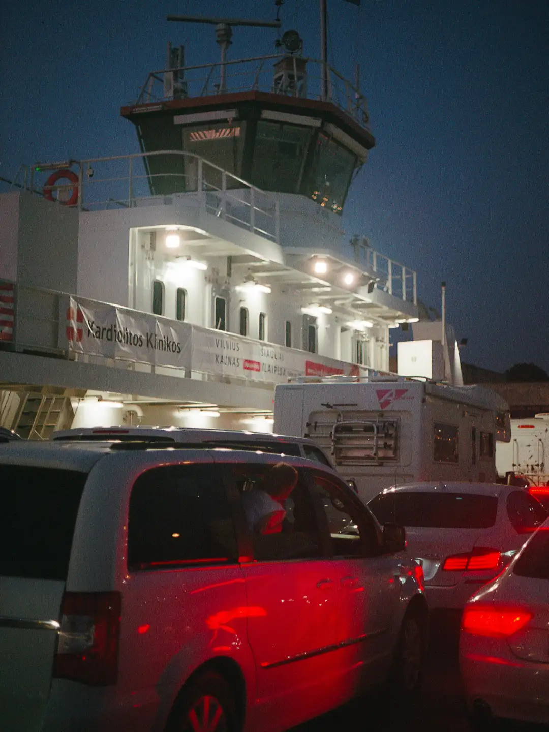 A boat full of cars that's transfering them. Created and photographed by Hiroku