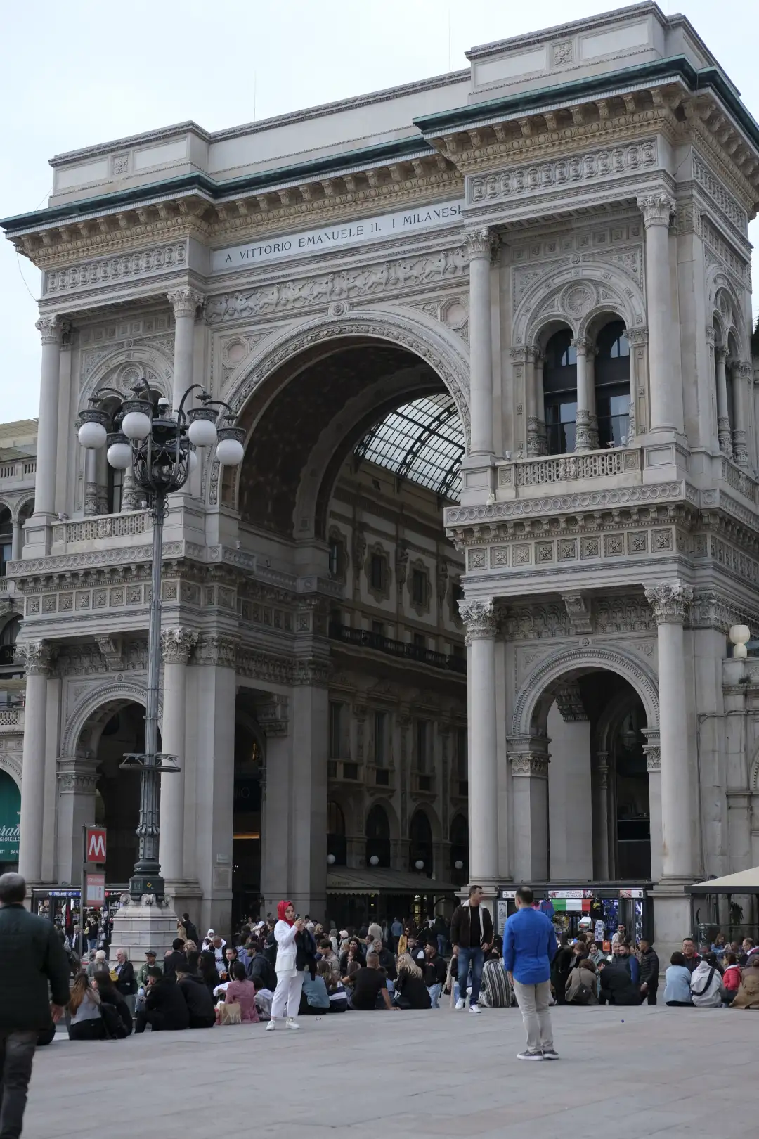 A huge arch with a huge crowd of people going through it. Created and photographed by Hiroku
