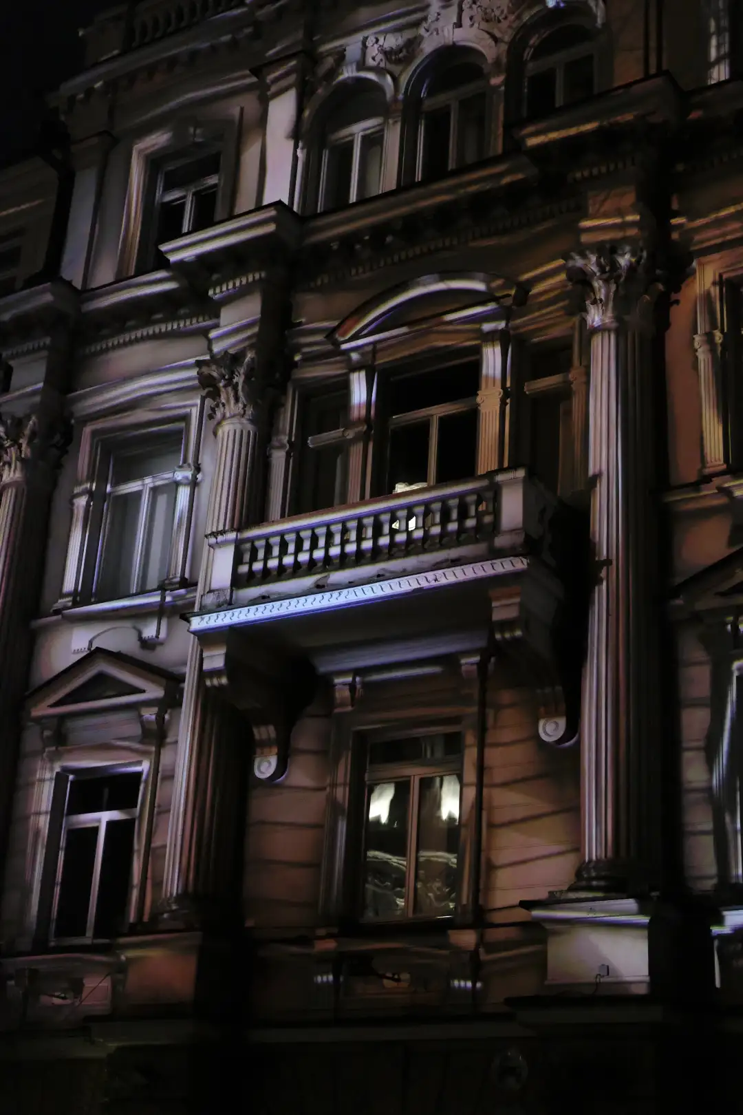 A trippy image of a building with a 3D projection on top of it. Created and photographed by Hiroku