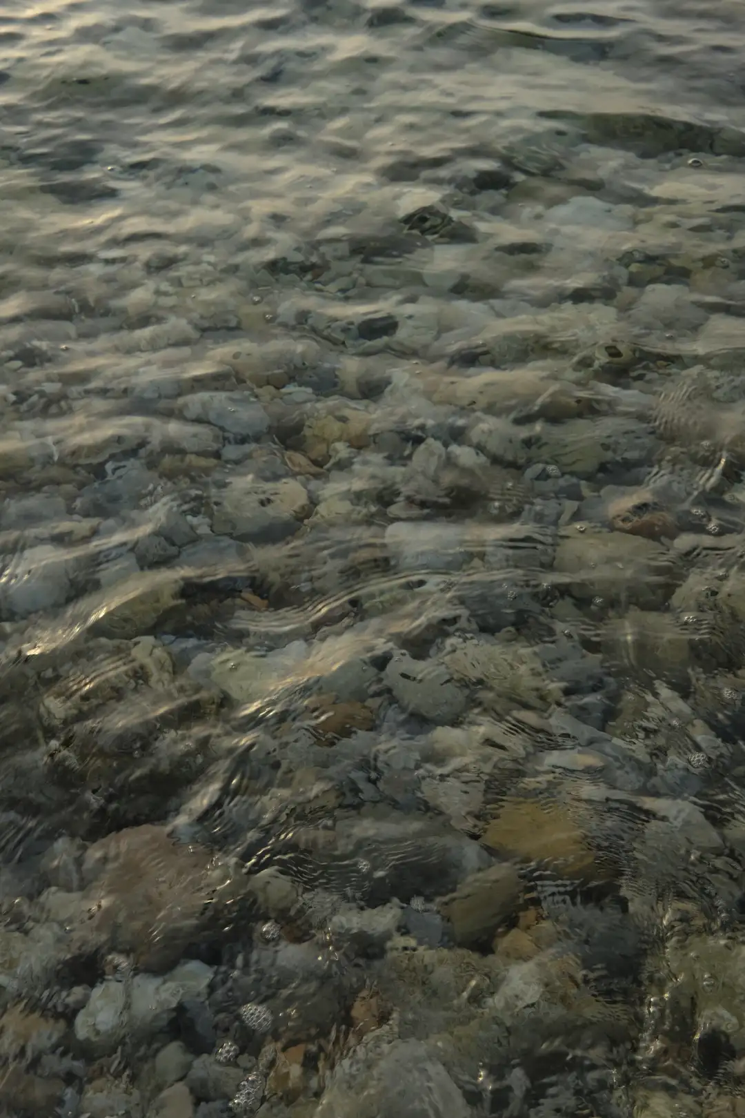 Underwater rocks photographed below the surface of a clear ocean. Created and photographed by Hiroku