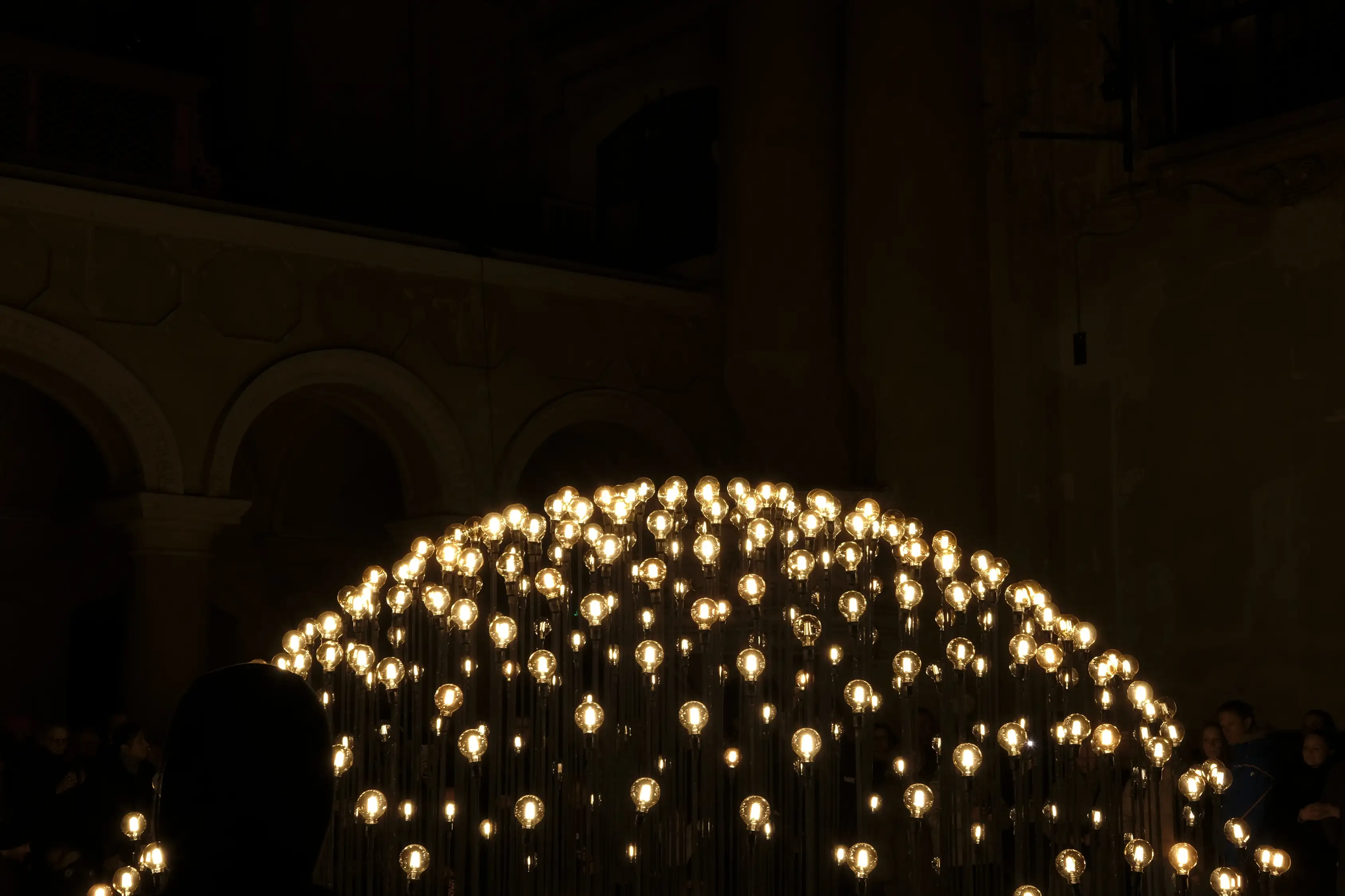 A photo with a visually interesting light sculpture made out of light bulbs. Created and photographed by Hiroku