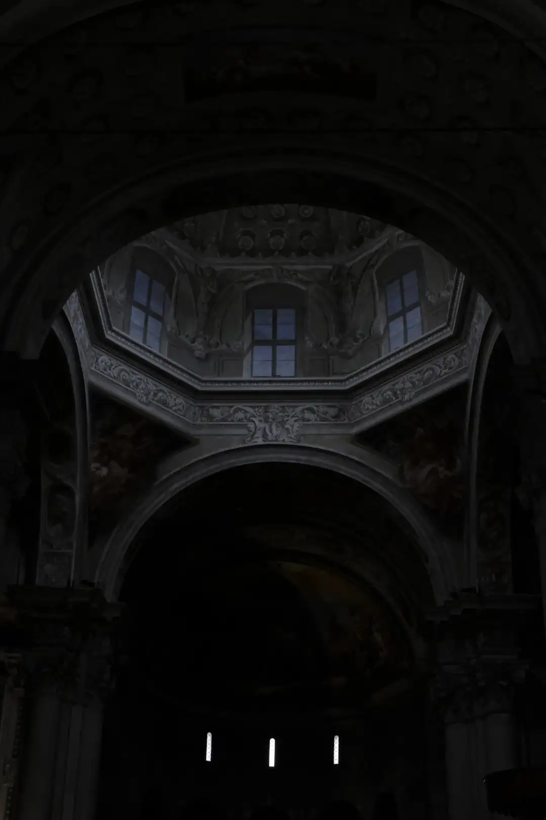 A dark church interior being lit up a dim blue sky light. Created and photographed by Hiroku