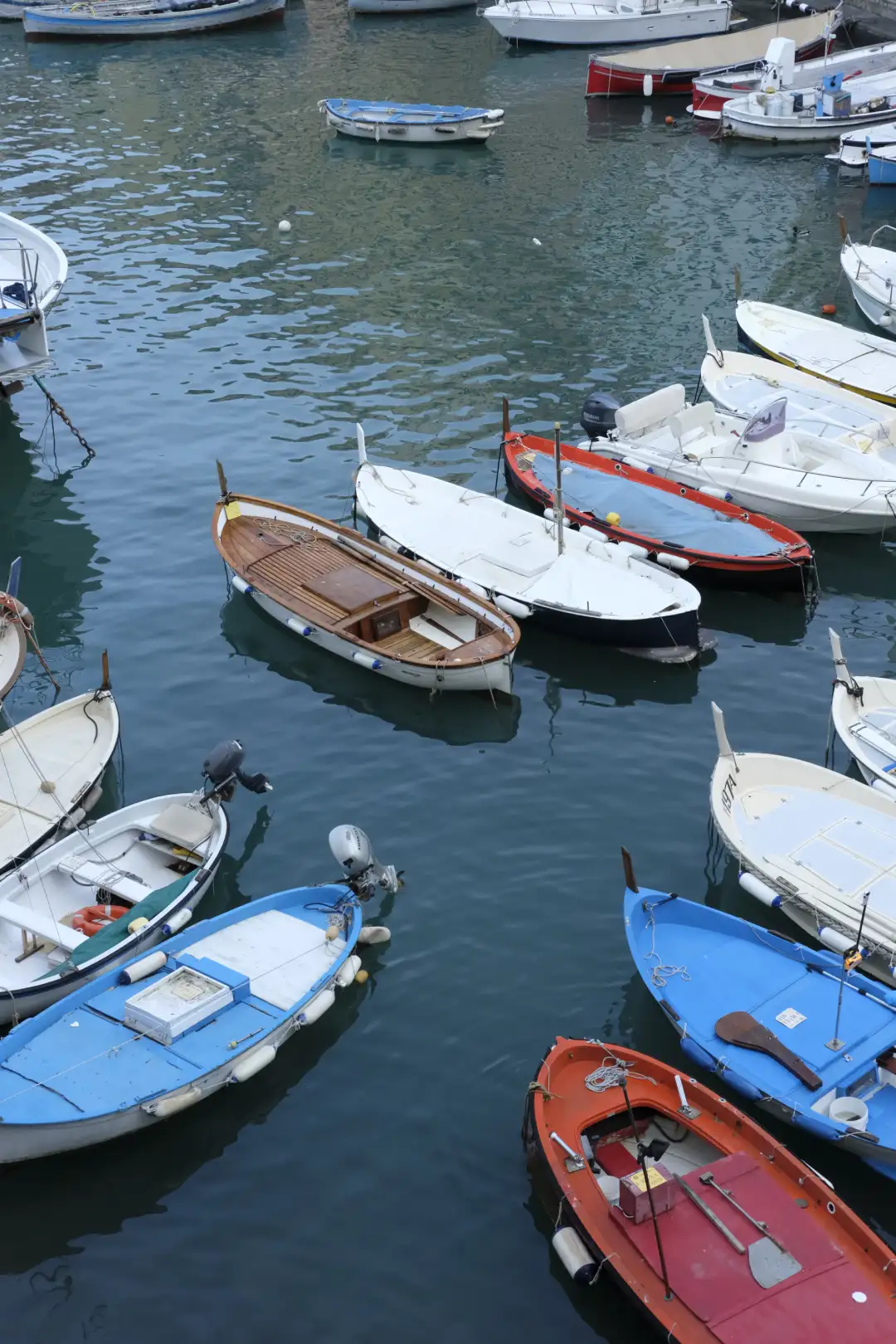 An image of a bunch of small boats set in a port. Created and photographed by Hiroku