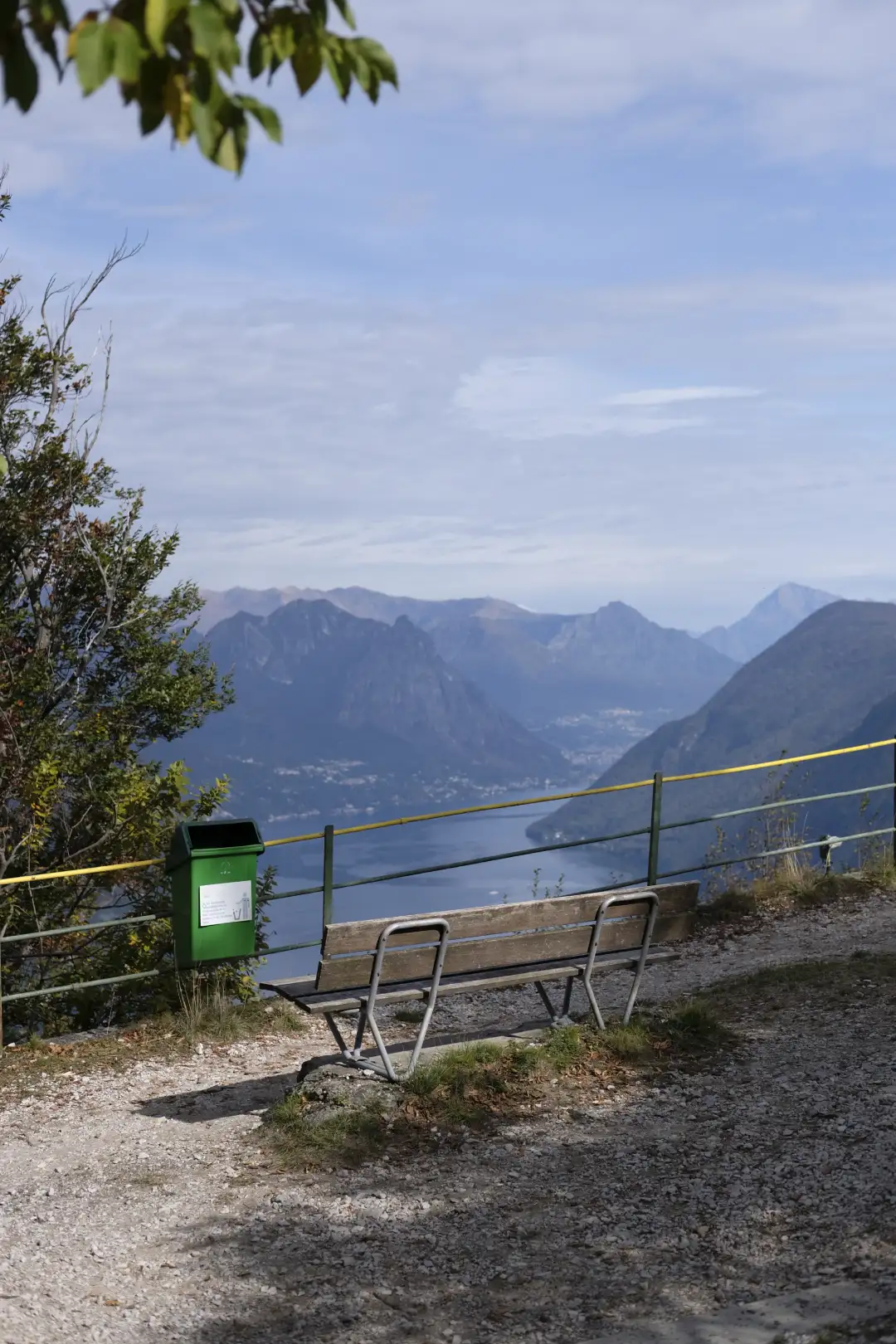 A bench overlooking a beautiful mountain landscape. Created and photographed by Hiroku