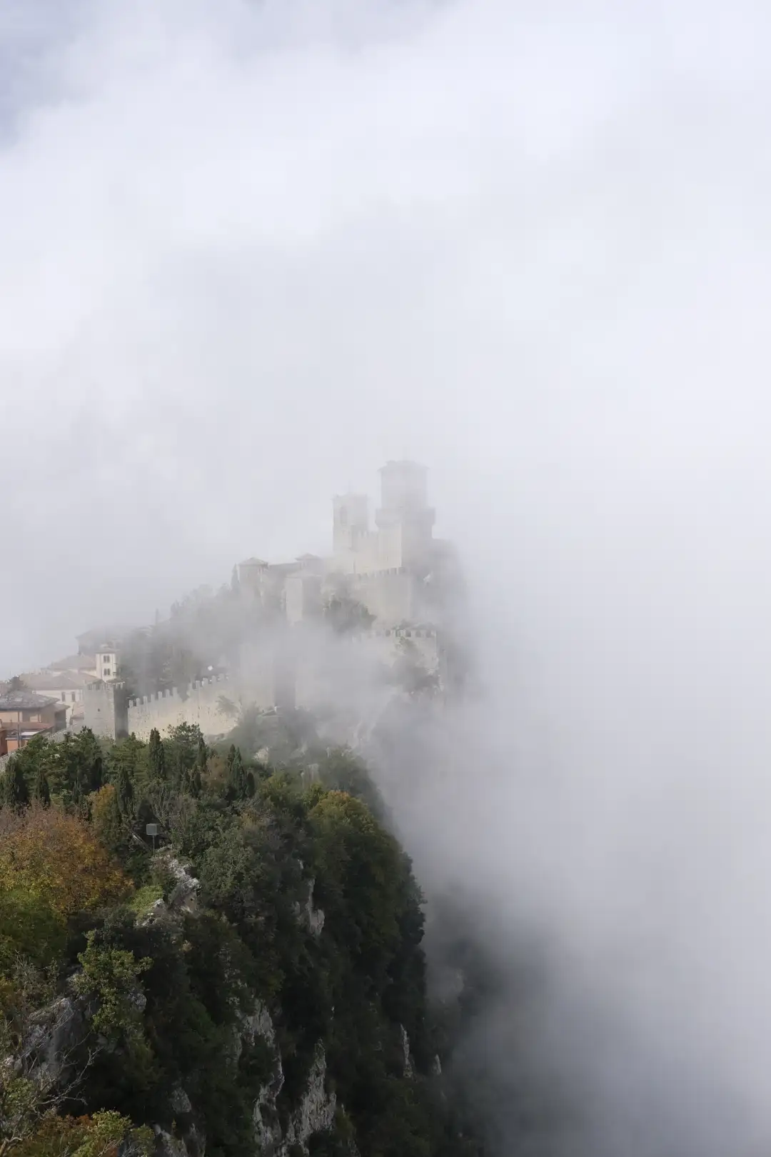 An old castle hidden in a bunch of white fluffy clouds. Created and photographed by Hiroku