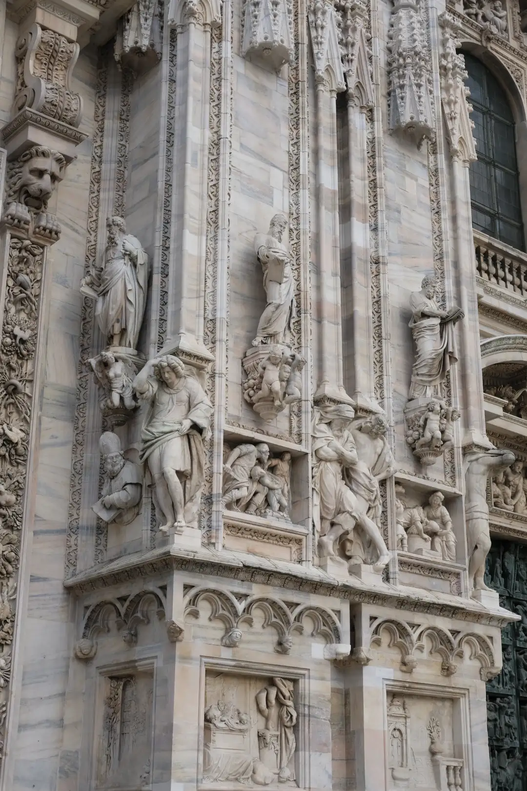 Architectural photo depicting an old church wall with interesting sculptures. Created and photographed by Hiroku